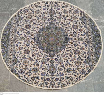 A detailed, elegant Kashan Persian rug with a central medallion on a crimson field
